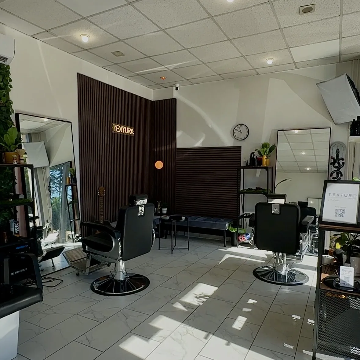Interior of TEXTURA Salon with two barber chairs